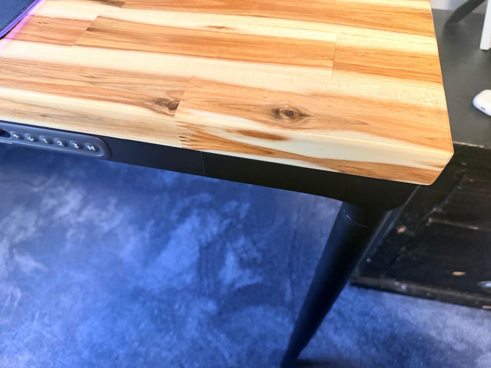 Parsons in a real room with other furniture visible, showing how the desk integrates into a shared space