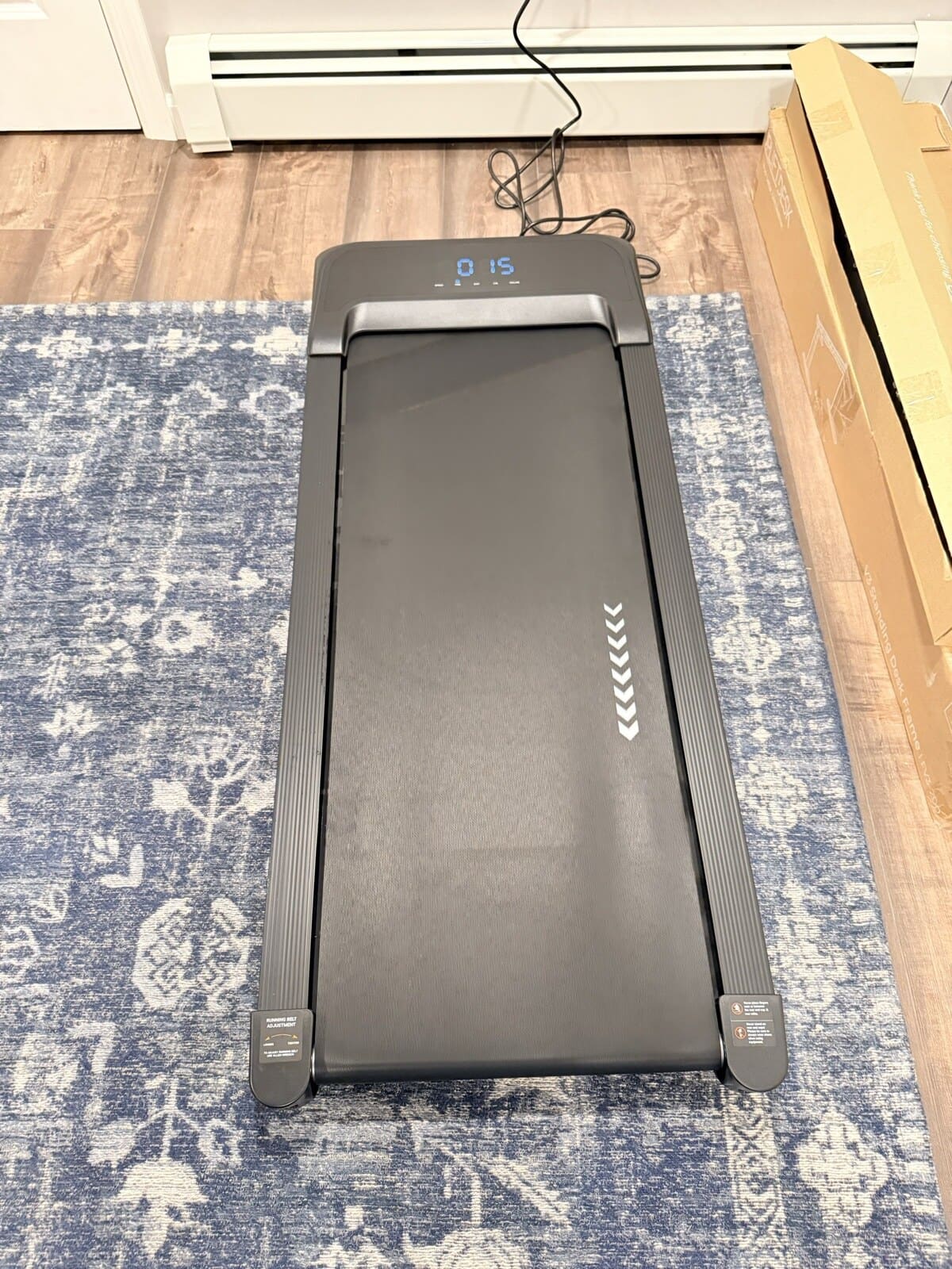 UPLIFT Inclining Walking Pad powered on under the V3 desk
