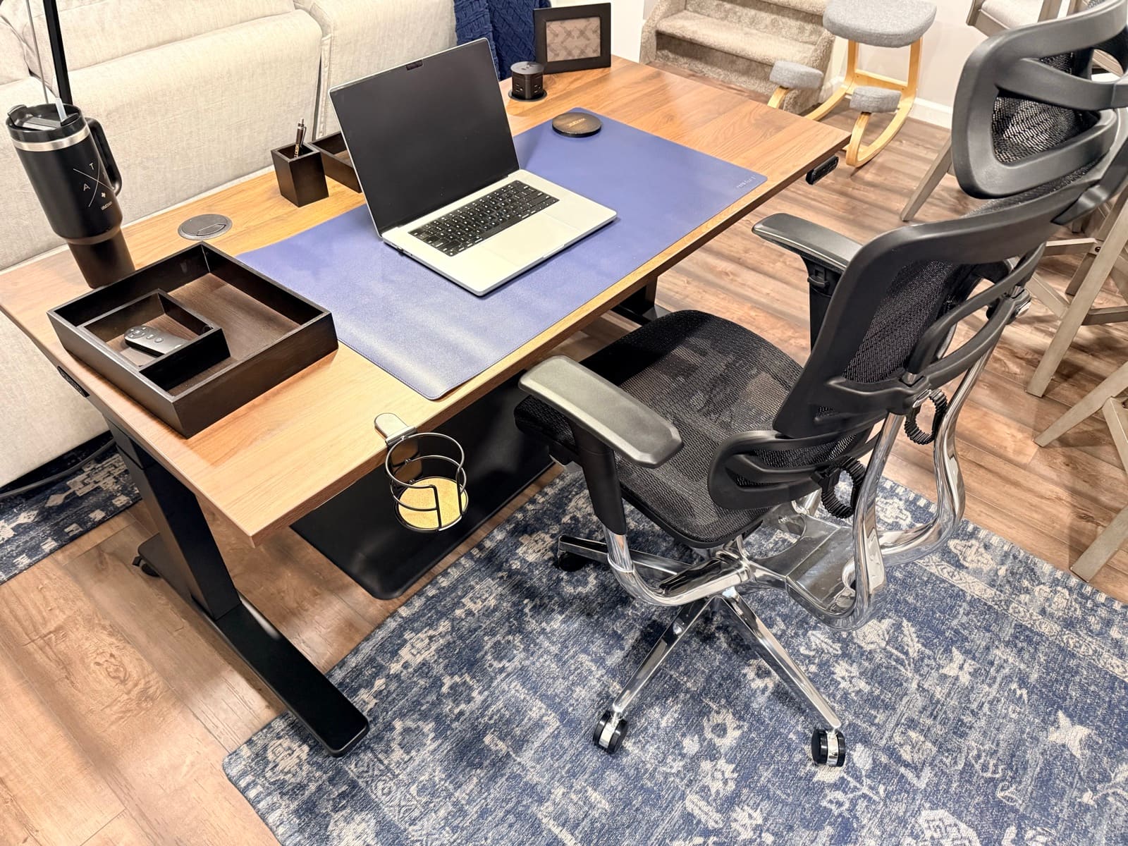 UPLIFT V3 setup with laptop, desk mat, cup holder, and chair